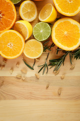 Fototapeta na wymiar Flat lay composition with ripe citrus fruits and rosemary on wooden background