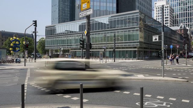 Urban scene in the City of Frankfurt Germany with crossroads, pedestrians, trams, cars  and other traffic  - time lapse