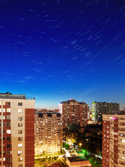 Star tracks over Odintsovo town, Moscow region, Russia. Long exposure of starry night sky.