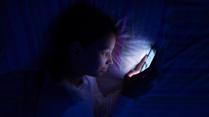 digital modern device addiction. gadget night sleeplessness. young caucasian girl browsing chatting playing serfing network with tablet bed. mobile phone apps. - obrazy, fototapety, plakaty