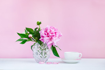 A cup of tea and peonies