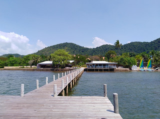 wooden pier yacht club and beach with mountains