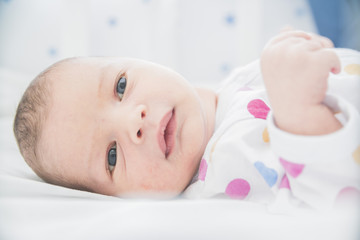 close-up baby newborn infant lying in bed