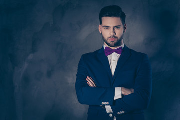 Portrait of pretty charming mrs in purple dress with jewelry half face mr in tuxedo bowtie holding hand in pocket of pants embracing his lover lovely attractive couple isolated on grey background