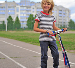 Happy child with a scooter