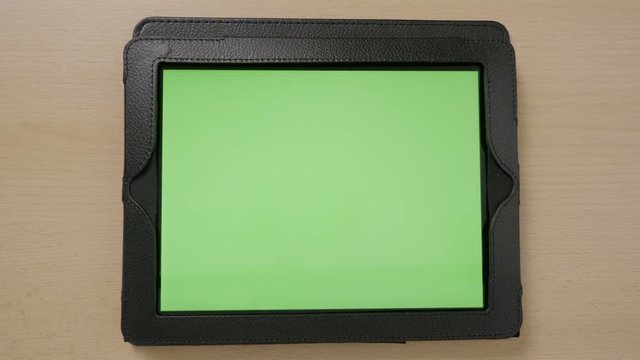 Top view of young woman hands touching tablet pc green screen browsing zooming in and out