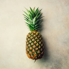 Pineapple on gray background, top view, copy space. Minimal design. Vegan and vegetarian concept. Square crop