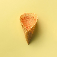 Ice cream cone on yellow background. Top view. Banner. Pattern for minimal style. Pop art design, creative concept. Square crop
