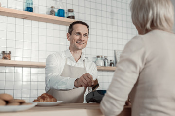 You are welcome. Joyful worker expressing positivity while holding credit card