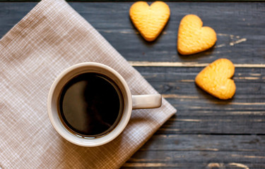 coffee on a wooden table with cookies hearts