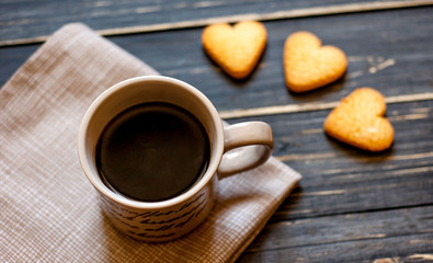 coffee on a wooden table with cookies hearts