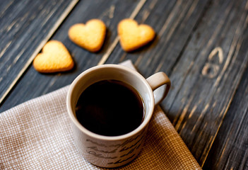 coffee on a wooden table with cookies hearts