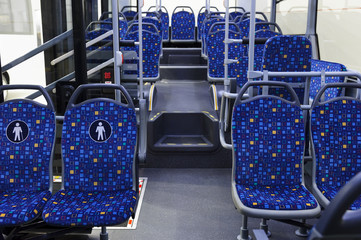 Bus inside, city transportation interior with blue seats in row, retirement places, open doors,...