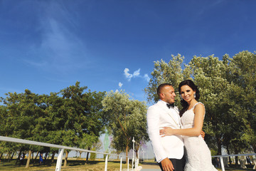 Beautiful wedding couple posing outdoor at dock