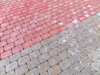 Paving stone on the street pattern brick surface. Grey and red abstract background