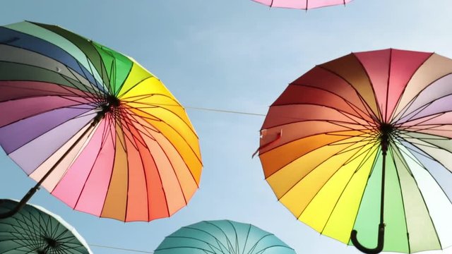 Multicolored umbrellas against the sky, close-up.