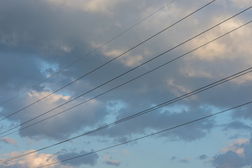 Electric wires with blue sky and clouds on sunset. Industrial concept. Background.