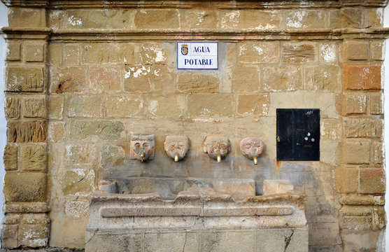 Picturesque fountain of drinking water with stone heads in the square of Grazalema village, route of the white villages, Cadiz province, Andalusia, Spain