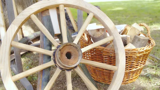 Carriage wooden wheel before wrapping into iron close-up 4K. Dolly shot of wooden wheel in focus before iron forged to protect the wooden elements.