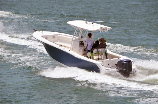 Helmsman and two passengers enjoying a sightseeing cruise on the florida intra-Coastal Waterway off Miami Beach