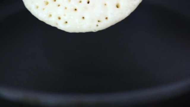 Flipping pancake on teflon pan.