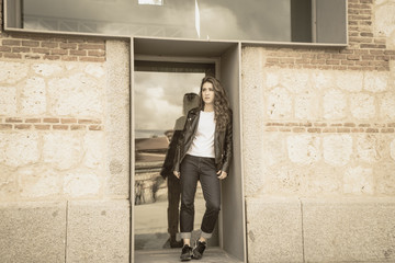 beautiful woman inside window with leather jacket