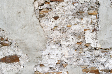 Old damaged wall of stones and concrete as background