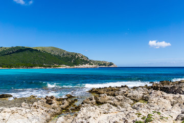 Naklejka na ściany i meble Mallorca, Rocky coast of bay Cala Agulla near Cala Ratjada at daytime