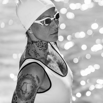 Portrait of female with tattoos posing by the pool