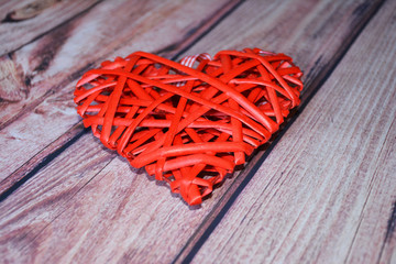 Red heart on wooden background