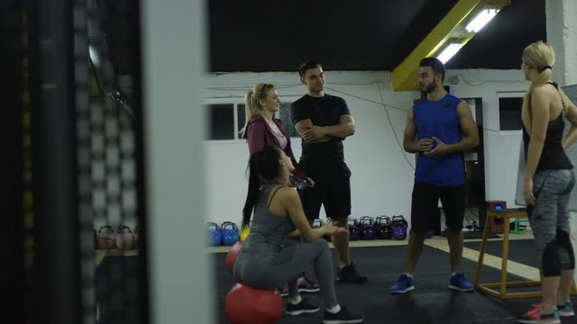 Group of sport people doing exercises in gym