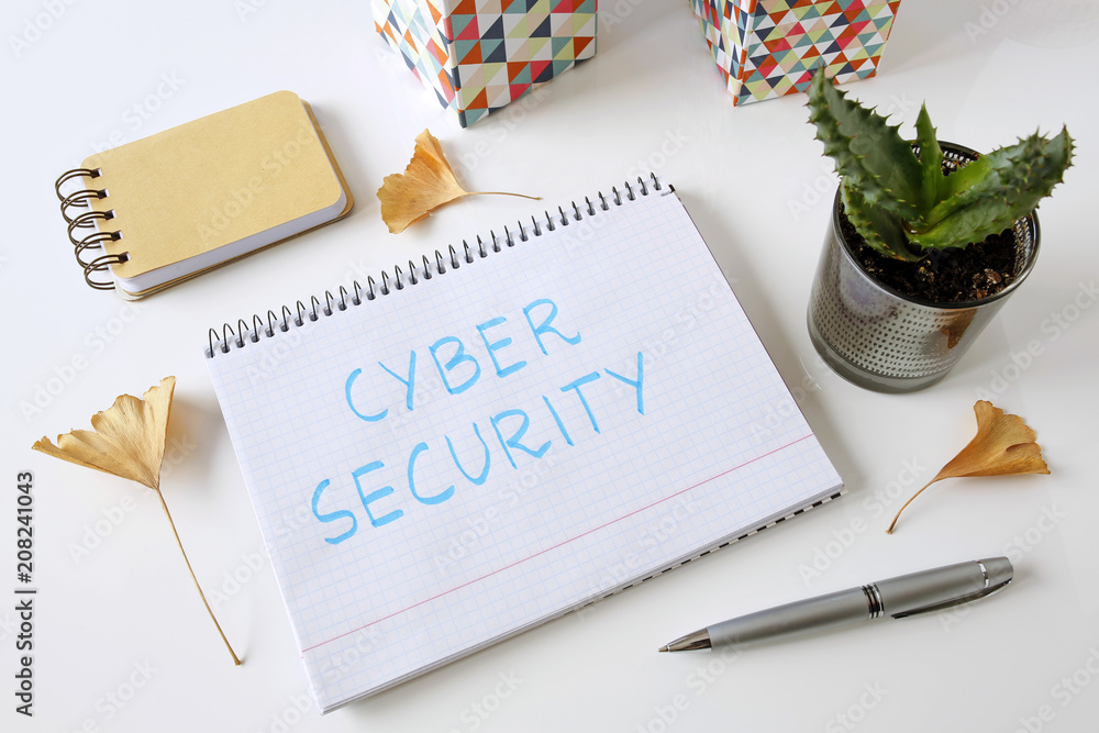 Poster cyber security written in a notebook on white table