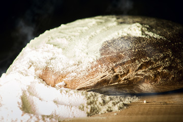 Hot bread with steam in flour