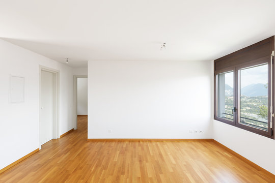White empty room with parquet in modern apartment