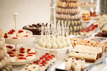 White cake pop and other sweets on candy bar