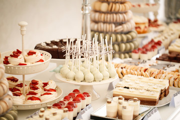 White cake pop and other sweets on candy bar