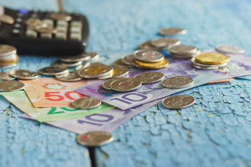 Canadian dollars, coins and calculator on the wooden background