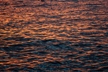 Fototapeta na wymiar texture of water with sunset light, Etretat, Normandy, France