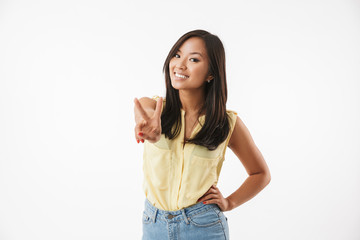 Happy young asian woman showing peace gesture.