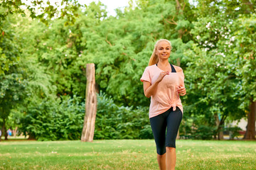 Young woman running on a field	