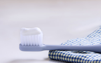 Toothbrush and handkerchief on the white table.