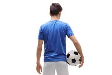 Poster Rear view shot of a teenage soccer player holding a football © Ljupco Smokovski