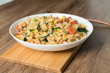 Fried rice with egg and wood grain background