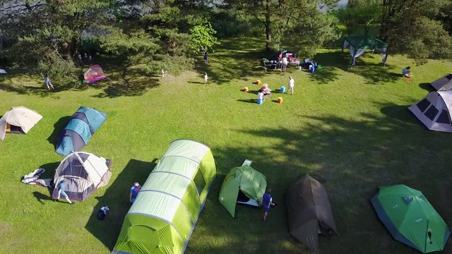 Aerial camping tents at a big green meadow territory people nature weekend rest in Czech Republic