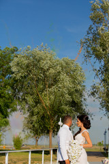 Romanic wedding couple posing in park