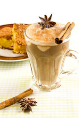Cappuccino decorated with star anise accompanied by fuba cake