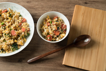 Fried rice with egg and wood grain background