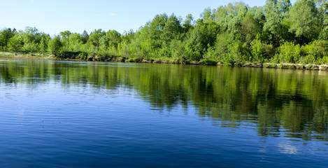 summer landscape. serene nature-green forest, clean river and a small beach.