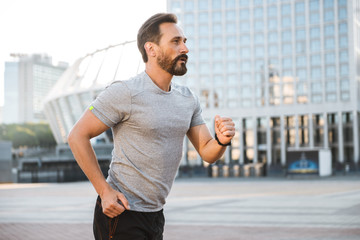 Handsome strong mature sportsman running