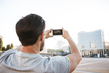 Back view photo of strong mature sportsman